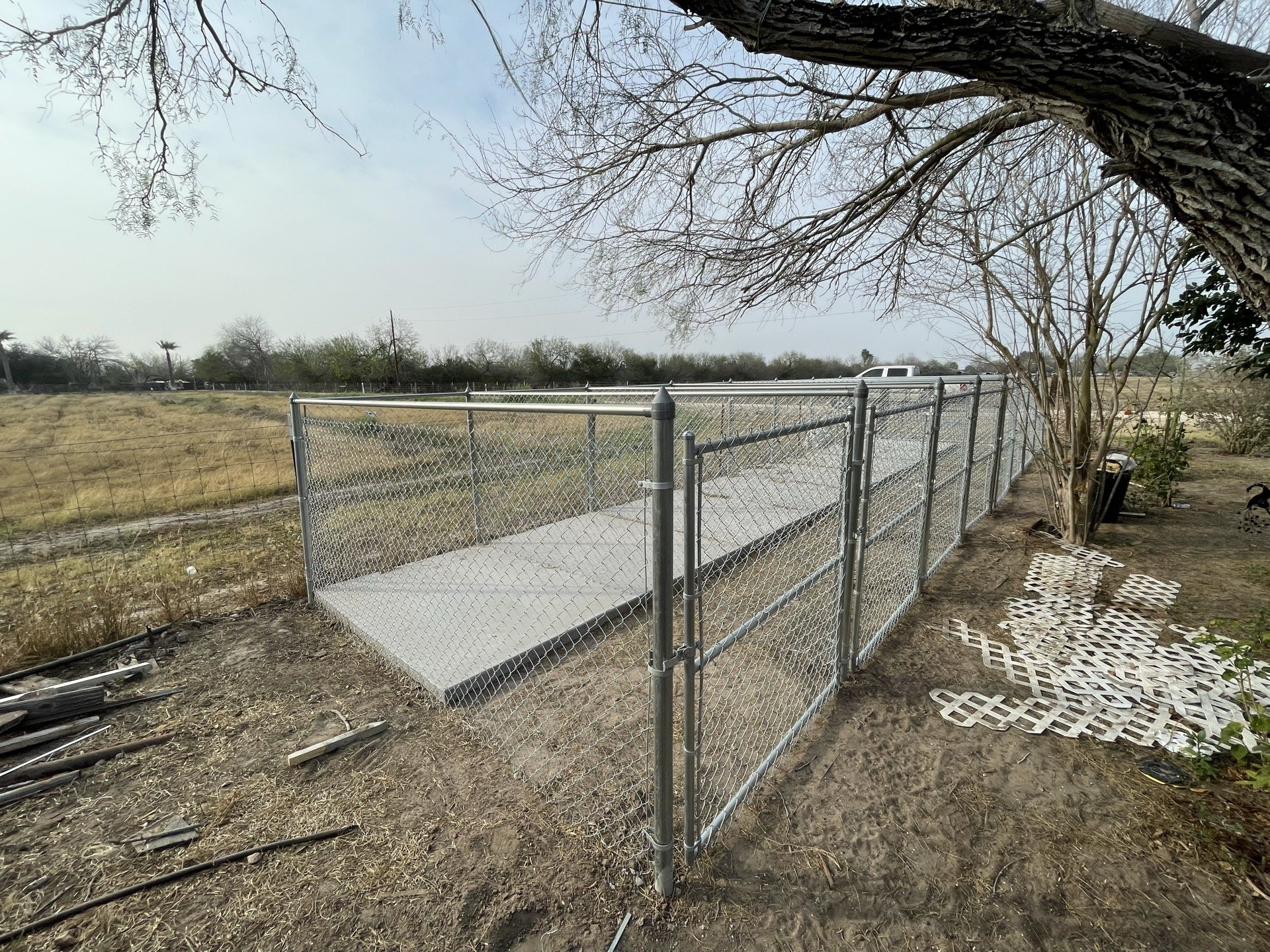 Chain-link enclosure and gate around a concrete floor in Edinburg