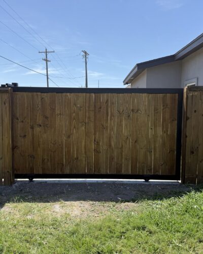 Wood-infill sliding gate with black metal frame in Hidalgo