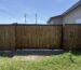 Wood-infill sliding gate with black metal frame in Hidalgo
