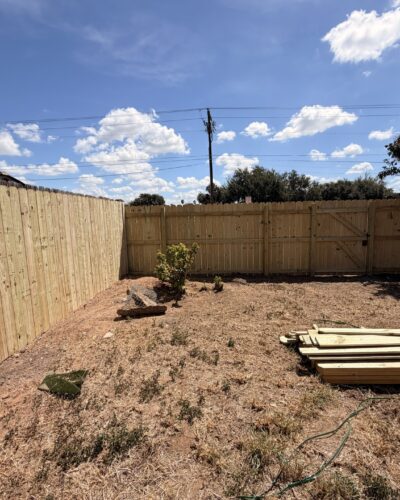 Wood privacy fencing meeting at a corner of a McAllen yard.