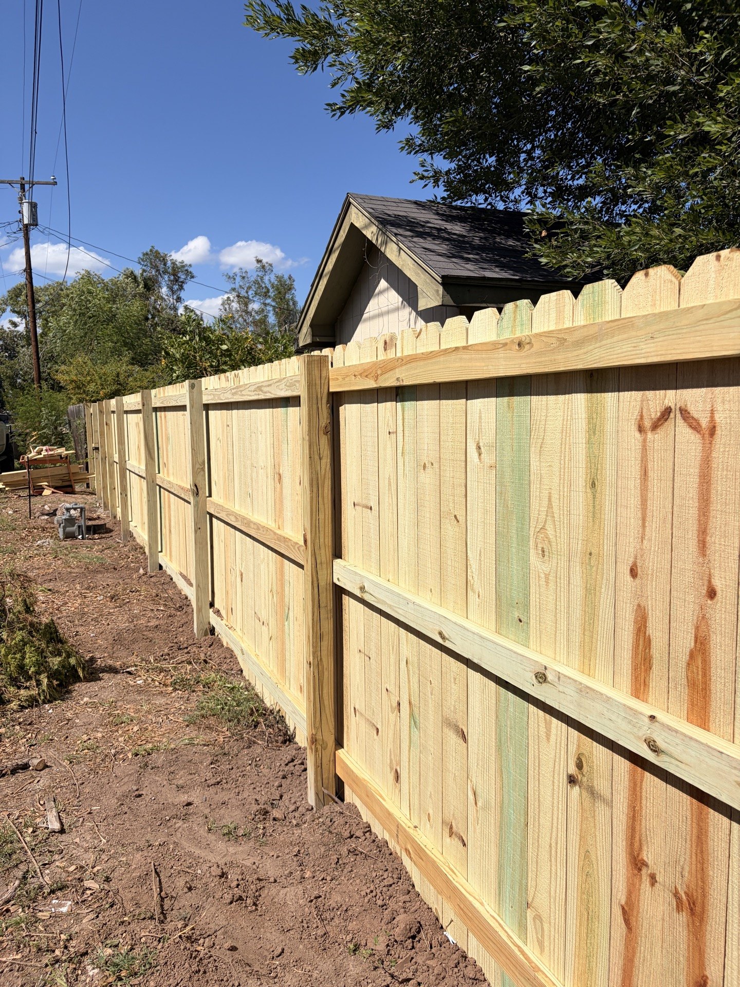 Wood pickets, rails and posts along an alley-side fence